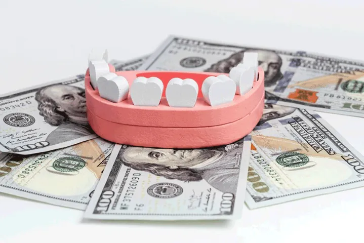 plastic teeth on top of money