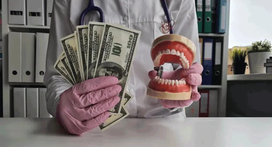 Dr holding fake teeth and money
