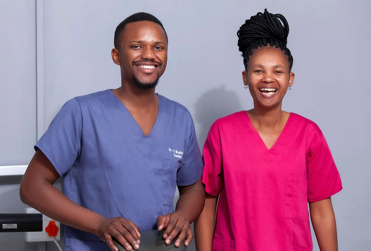 A portrait of Doctor Ukhona Nkunkuma standing with a receptionist
