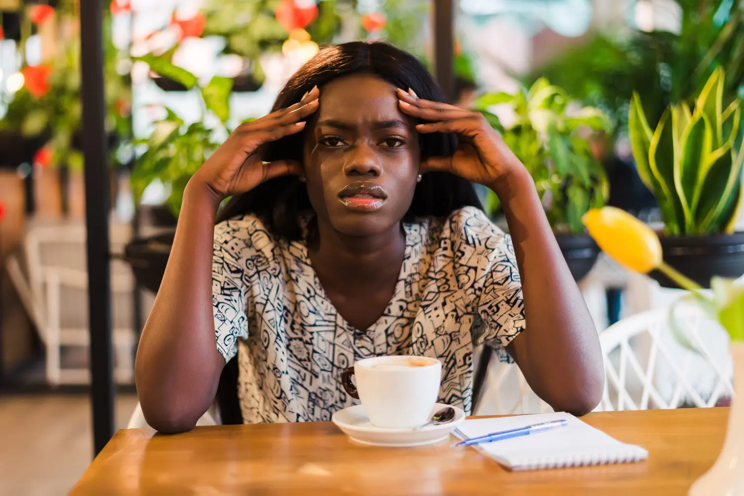 Black woman stressed touching her head